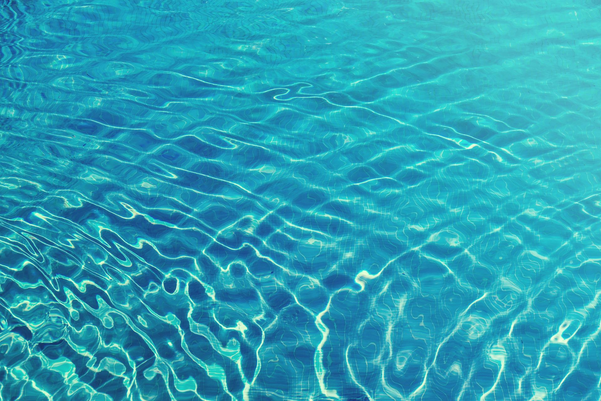 Sunlit ripples on clear turquoise water